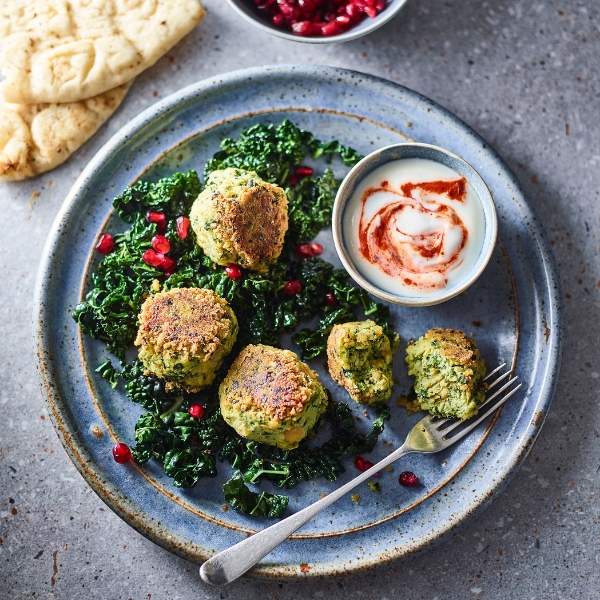 Cavolo Nero, Chickpea Falafels, Harissa on a plate with flatbread