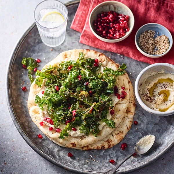 Harissa, kale and houmous flatbreads on plate