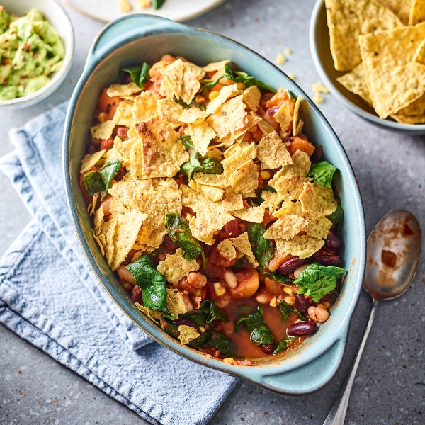 mexican bean, spinach and nacho crumble in an oven dish 