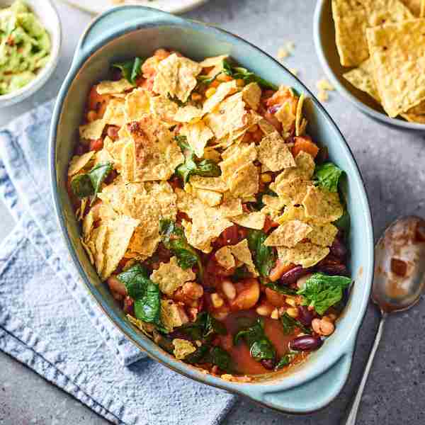mexican bean, spinach and nacho crumble in an oven dish 