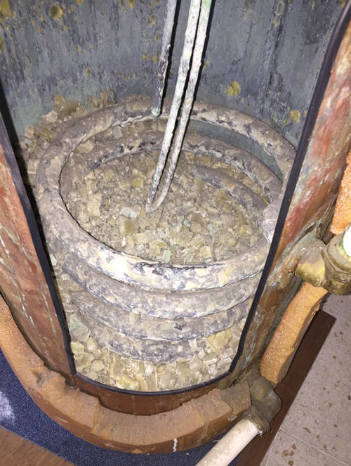 Hot water tank full of lime scale