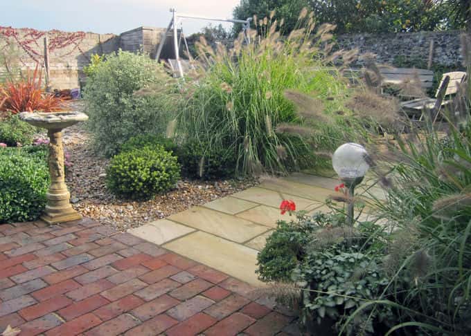 Grasses sway in the sea breeze in a stylish seaside garden Grasses sway in the sea breeze in a stylish seaside garden