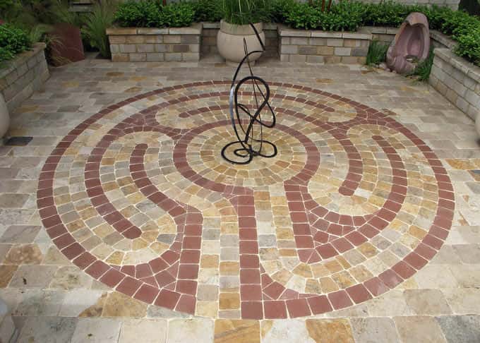 The central design is formed by bespoke sandstone paviors in contrasting colours