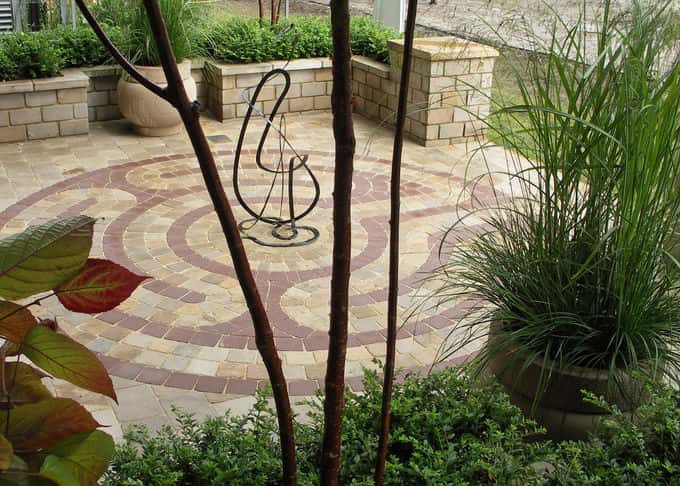 The central design is formed by bespoke sandstone paviors in contrasting colours