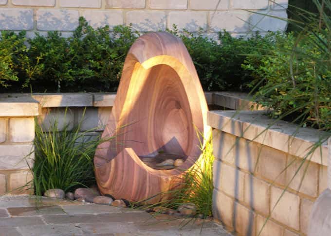 Water spills from an exquisite rainbow sandstone feature