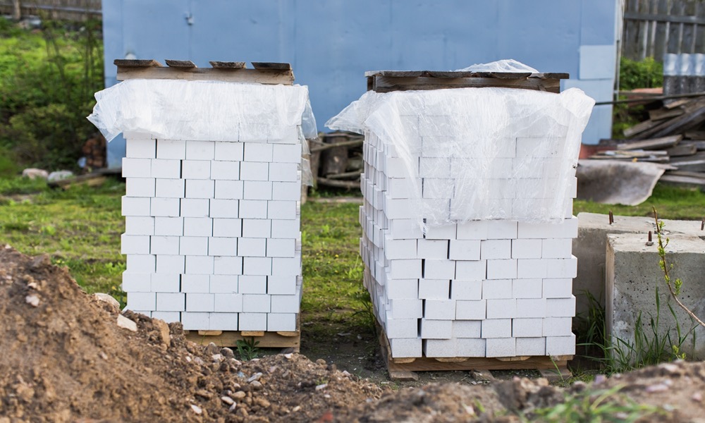 stacks of bricks covered with plastic sheets