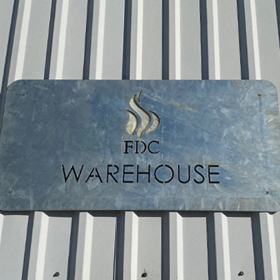 About Us Warehouse Sign