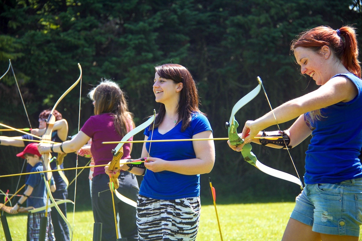 A group of friends taking part in Archery in Hampshire.