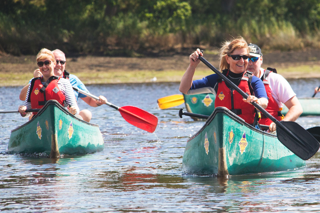 A group of friends enjoying private activities, canoeing on the Beaulieu River