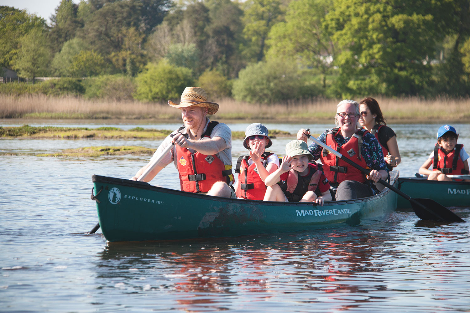 A family enjoying a guided canoeing session on the Beaulieu River