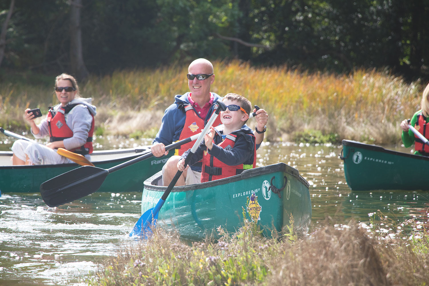 A father and son enjoying a Family Canoeing session on the Beaulieu River