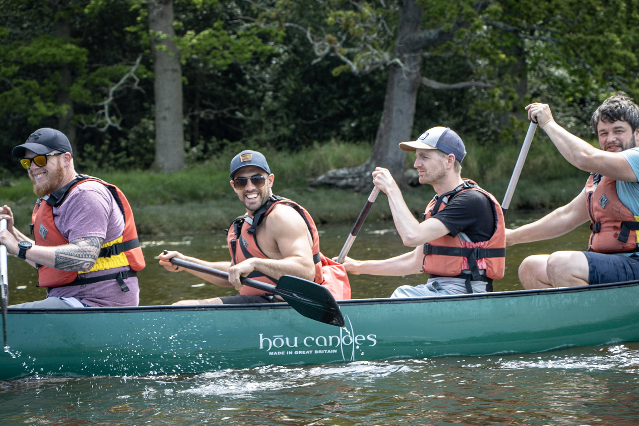 A group of women jumping into the Beaulieu River after their canoeing Hen Party with New Forest Activities