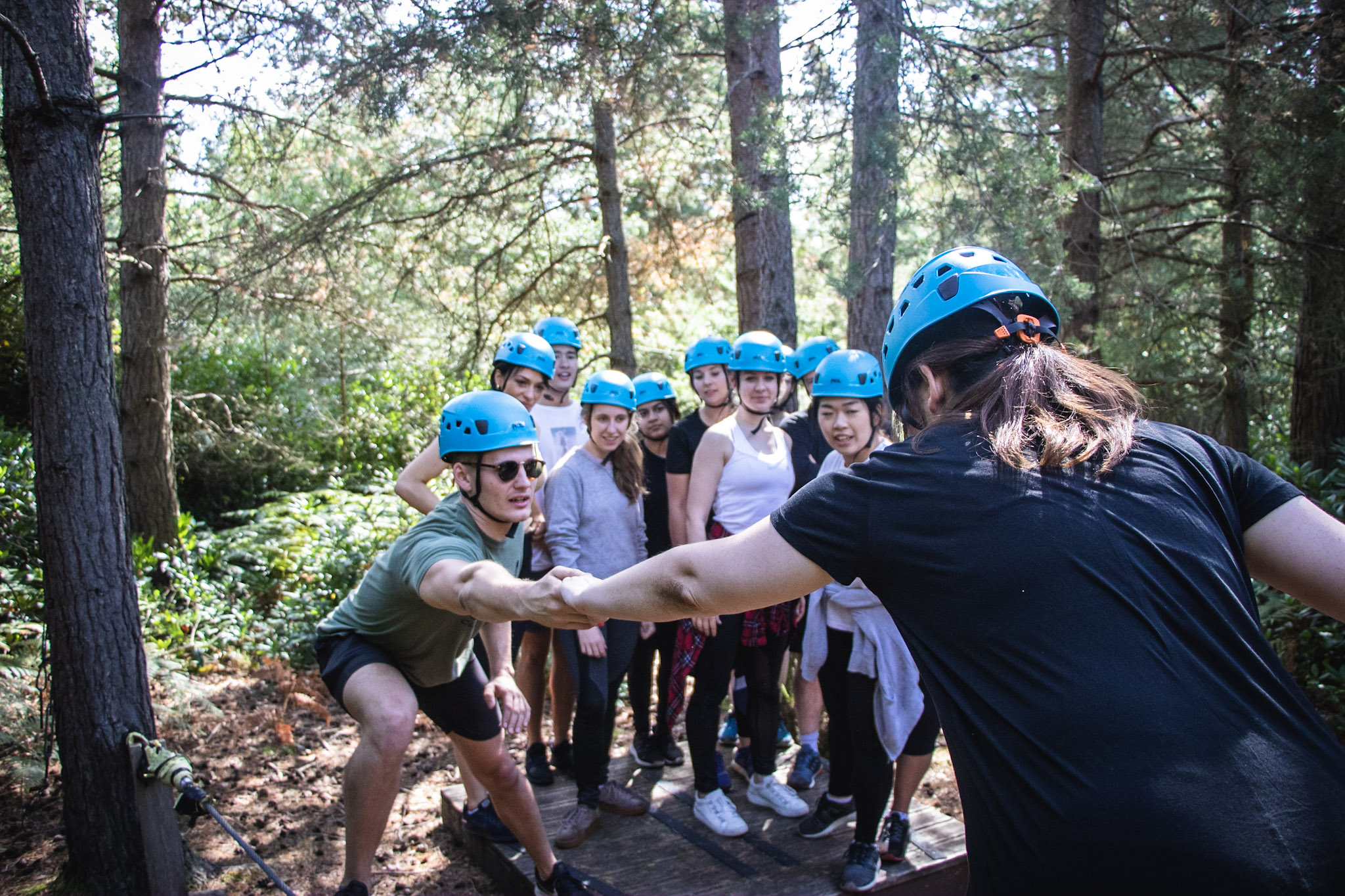 A team taking part in a low ropes activity
