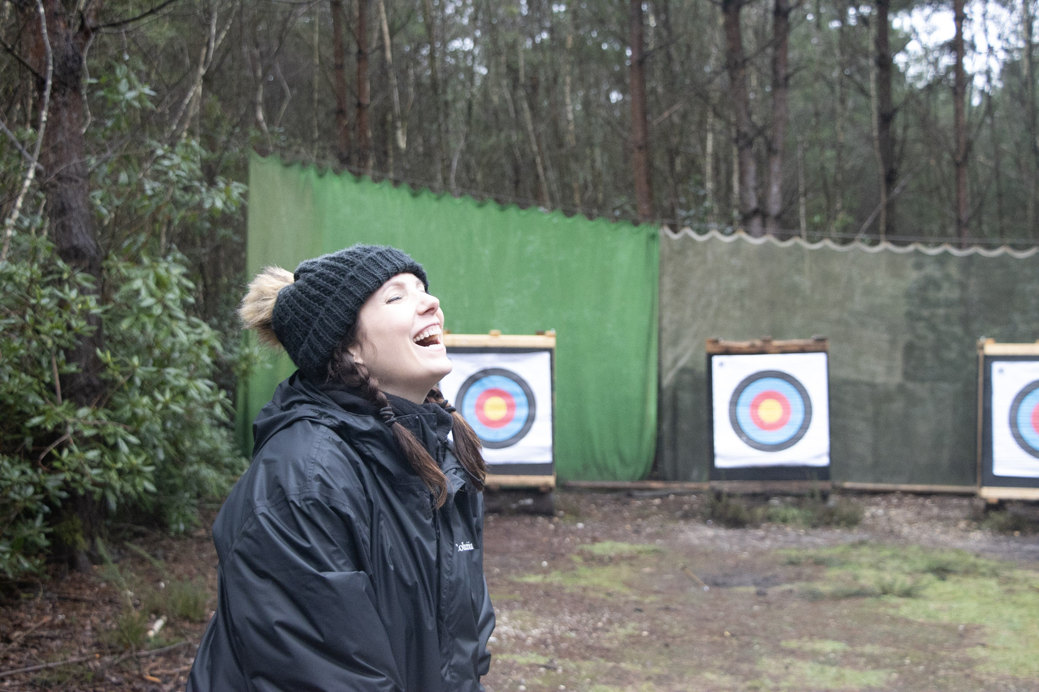 A woman enjoying archery as part of a Woodland Warmer day
