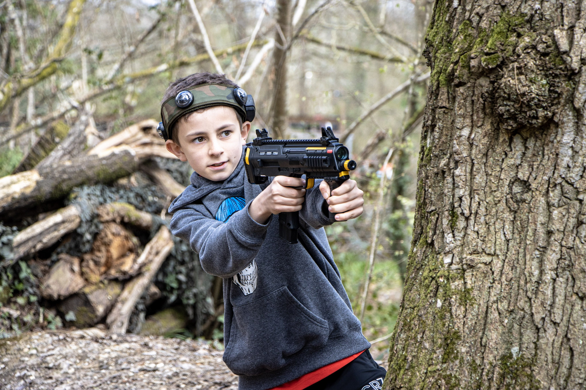 A boy taking part in BattleZone laser tag with his family