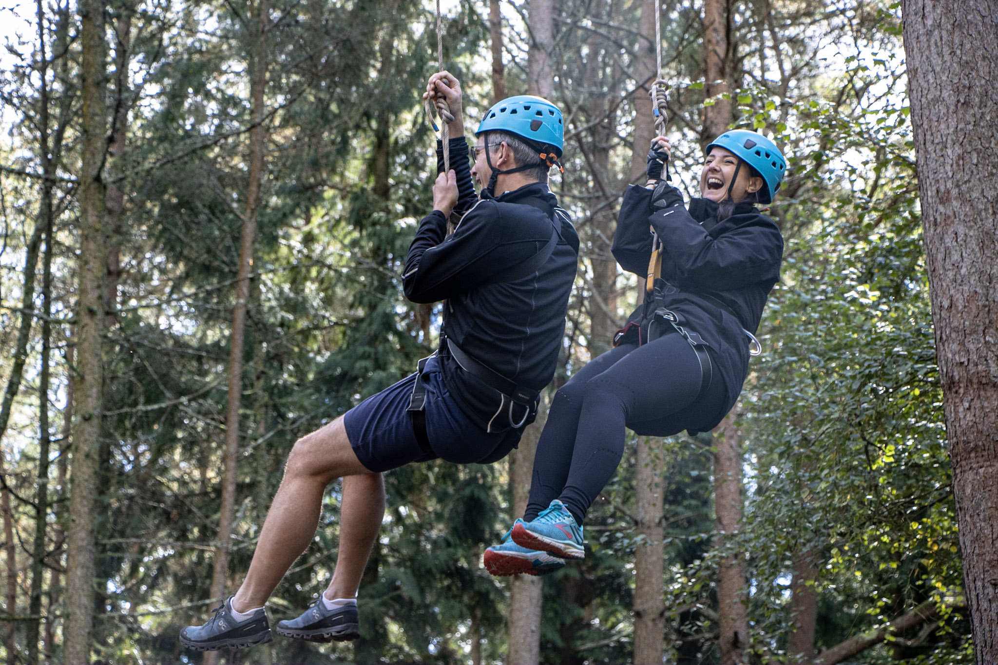 A couple of workmates enjoying high ropes as part of their Christmas office party