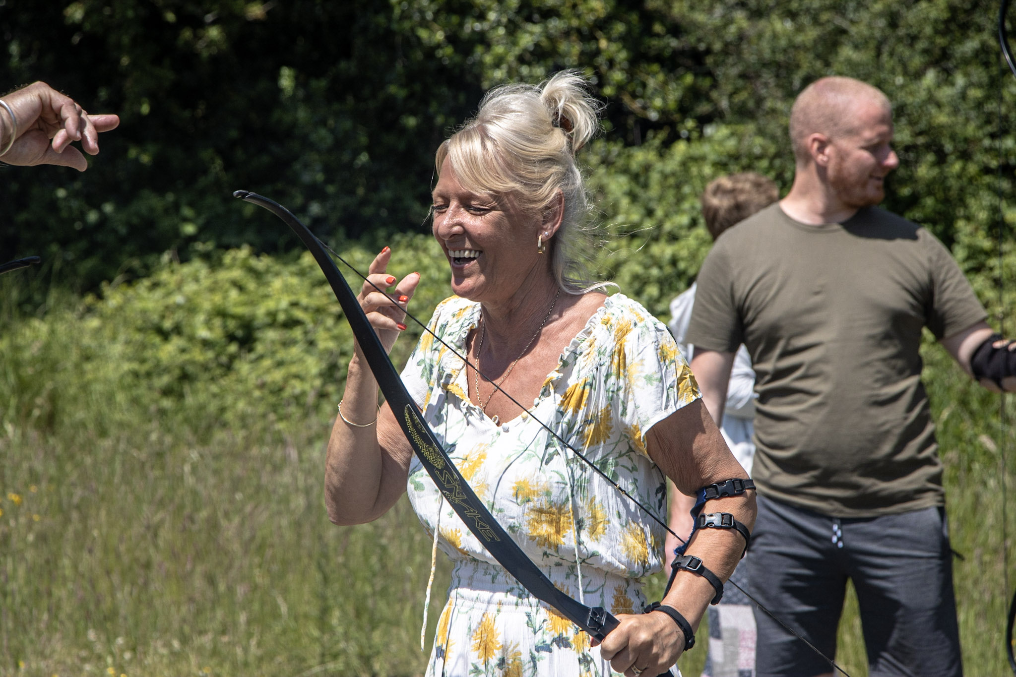 A woman playing Archery after looking for fun activities for adults in The New Forest.