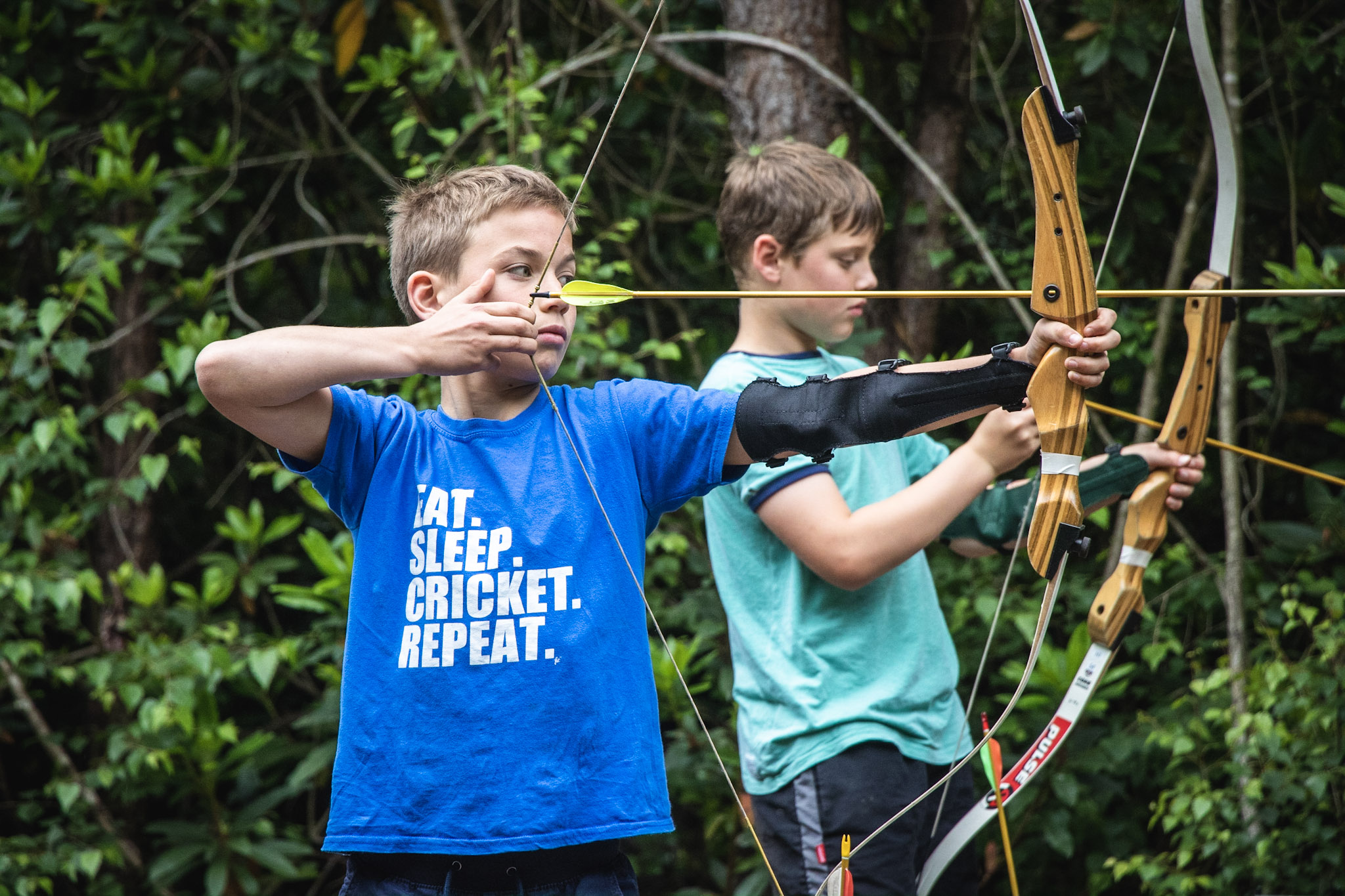 A boy taking part in an archery session in The New Forest