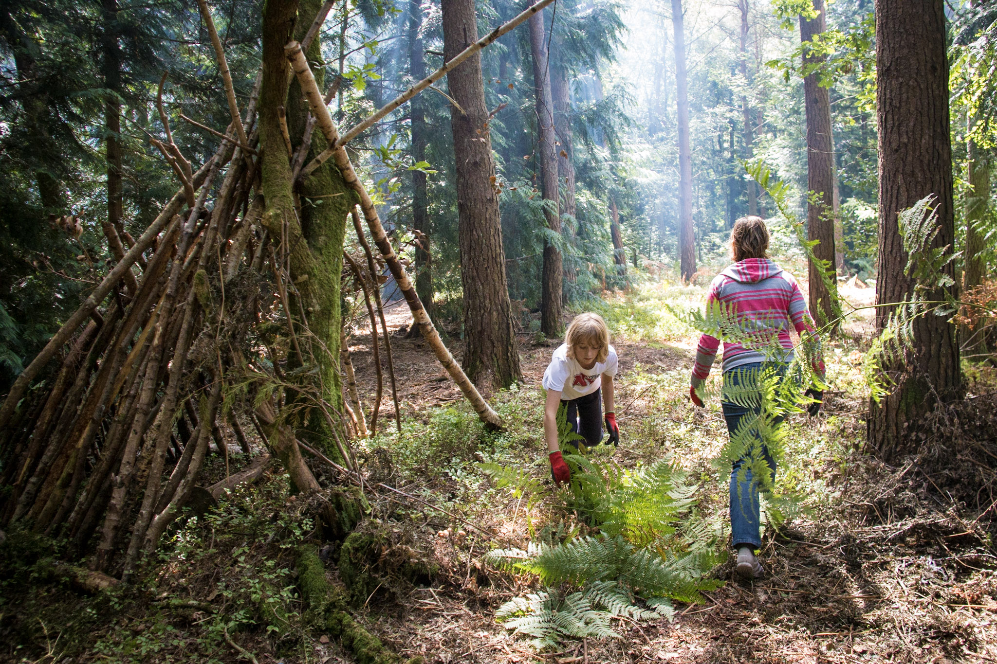 Children enjoying woodland holiday camp activities in the New Forest