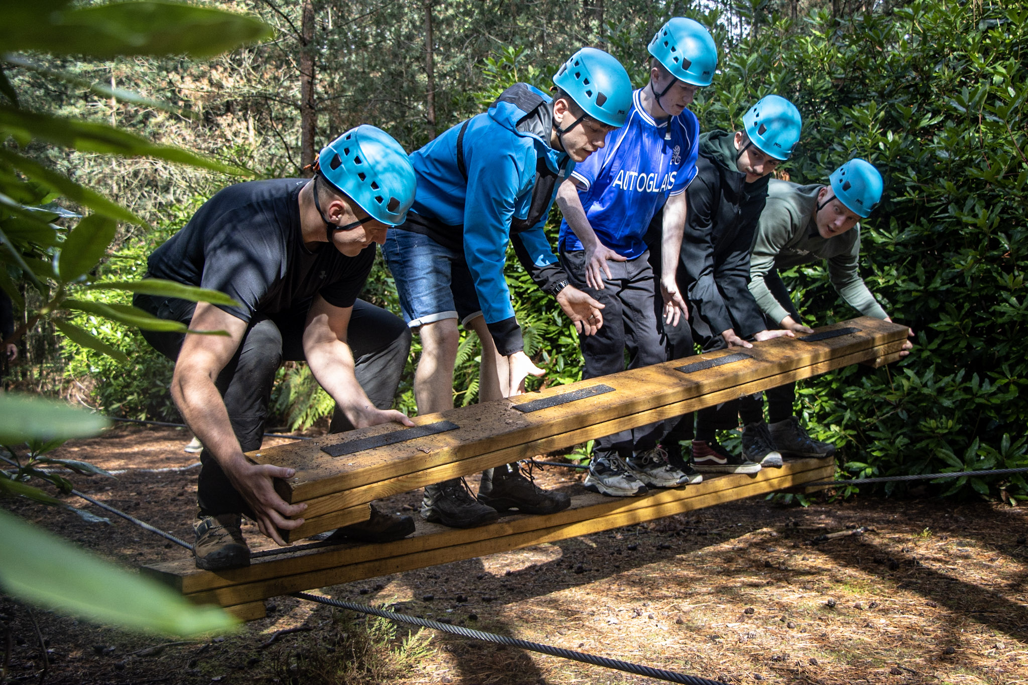 A wgroup of male business owners on the Low Ropes activity at New Forest Activities as part of a Circuir Breaker Day