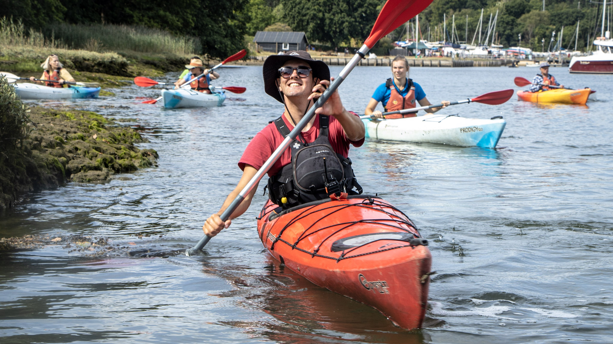 An Outdoor instructor smiling whilst delivering a kayaking session