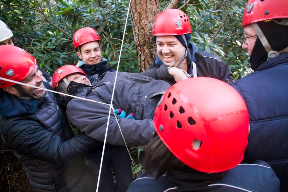 A group of men on the Low Ropes activity at New Forest Activities as part of a Team Building Day