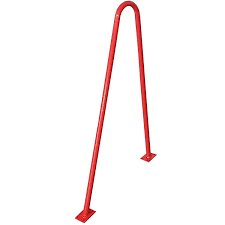 Red metal bike rack with a curved top and bolted base plates.