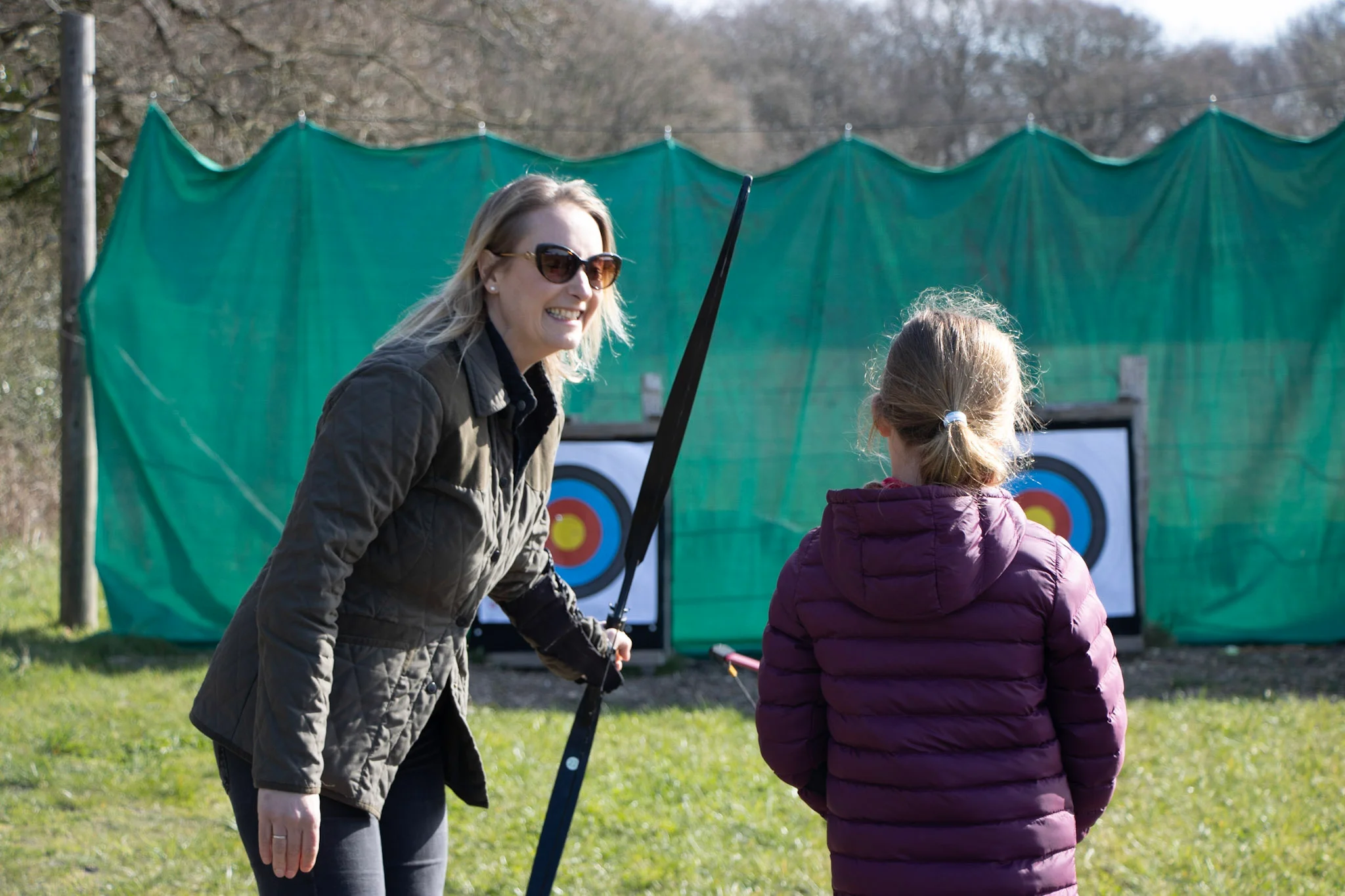 A mother and daughter taking part in Easter-themed archery
