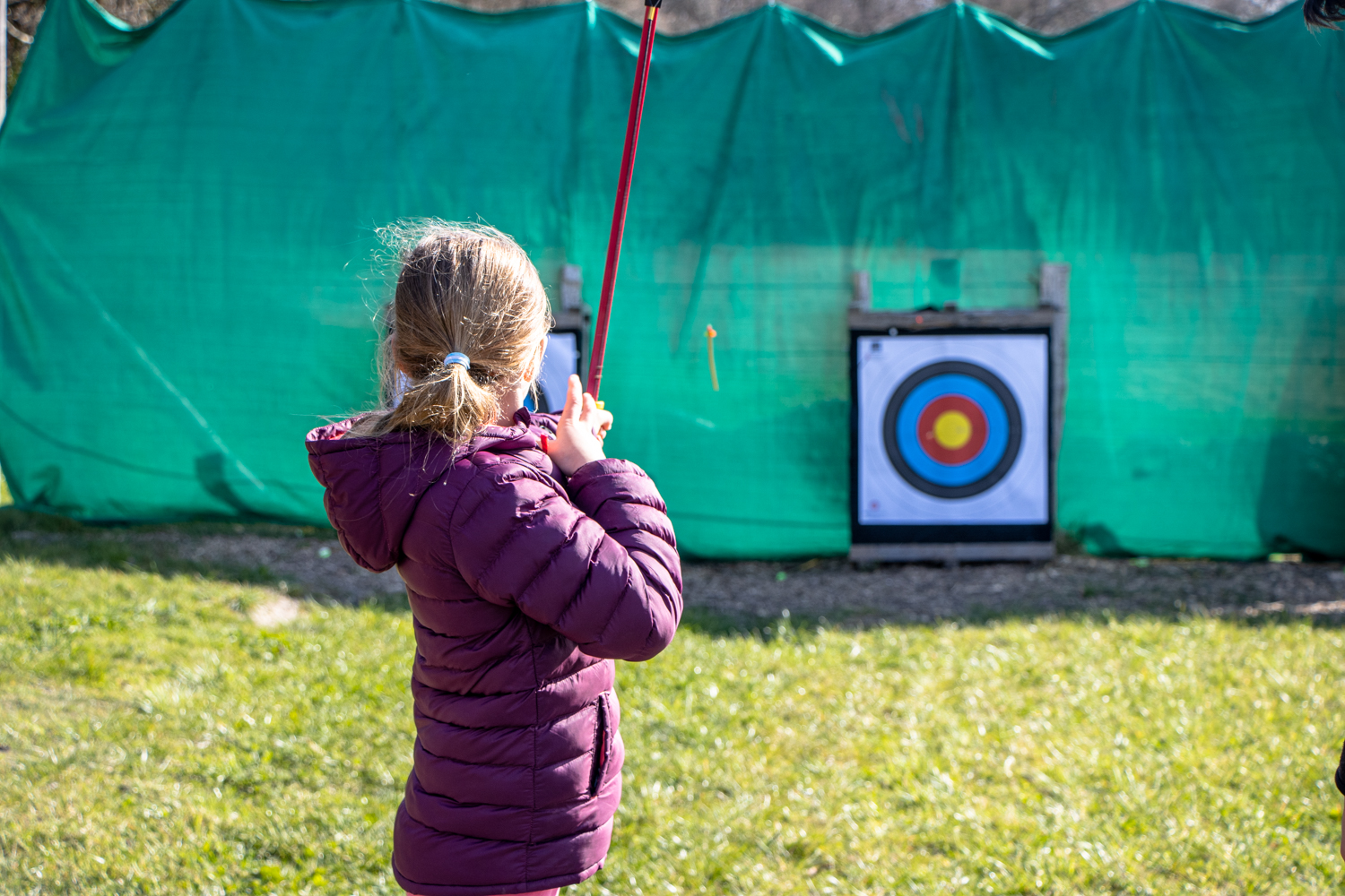A girl shooting arrows during a Family Archery session