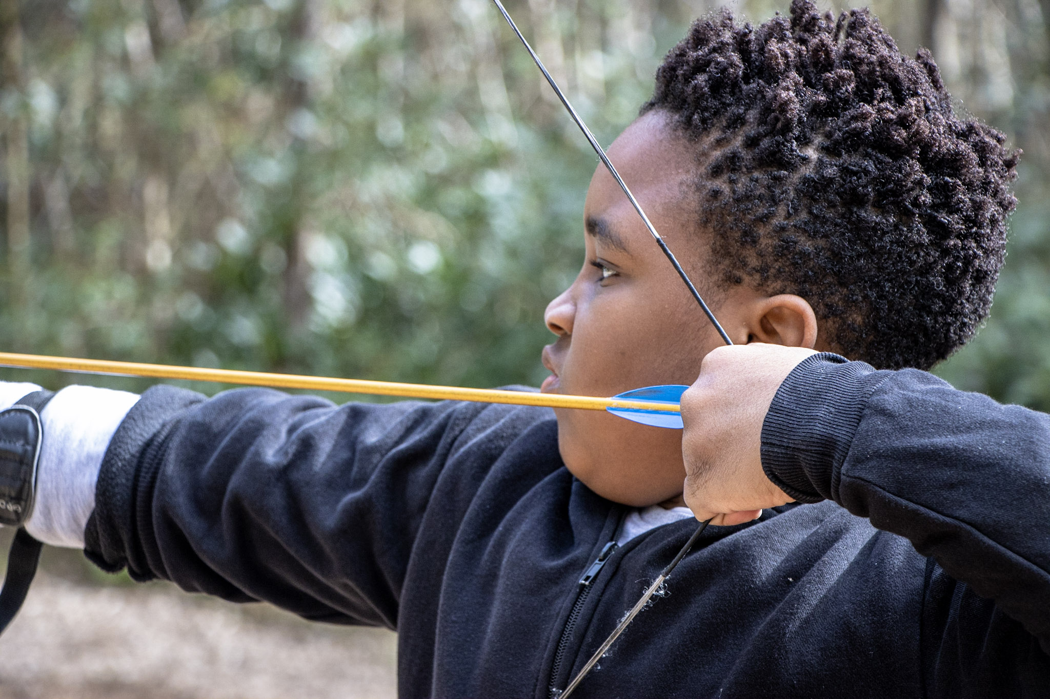 A boy enjoying an archery session with Cairngorms Activities