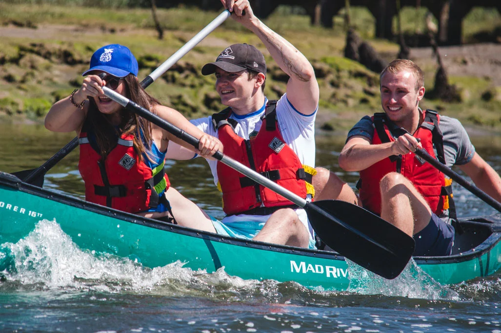 A corporate group canoeing on the River Spey as a half-day adventure option