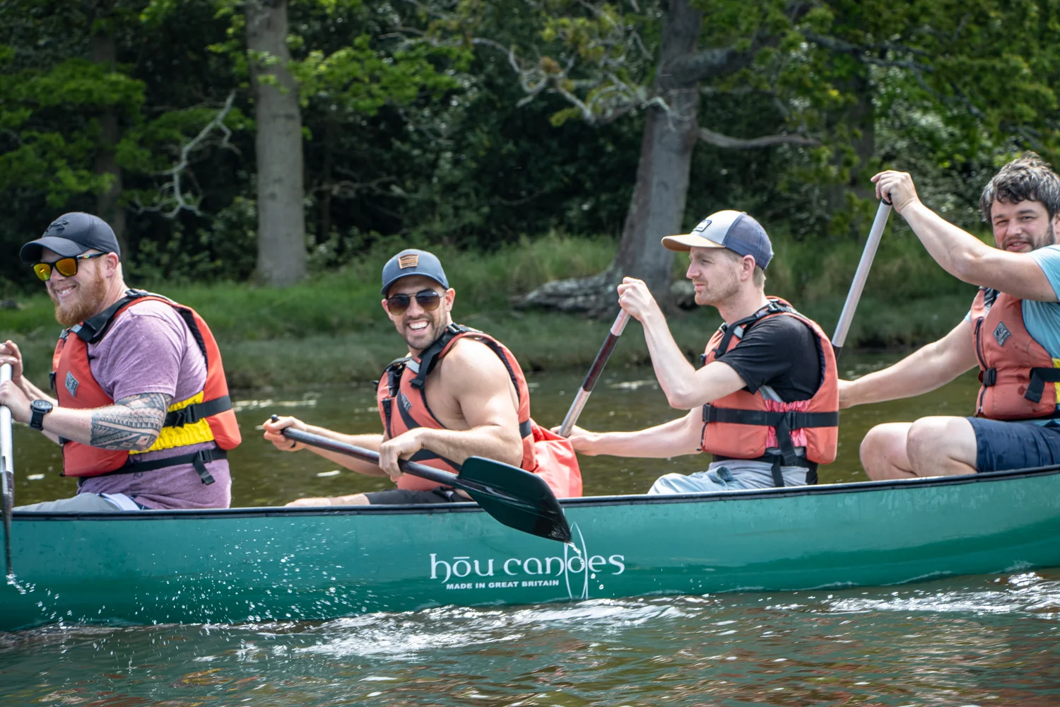 A group of friends canoeing on the River Spey