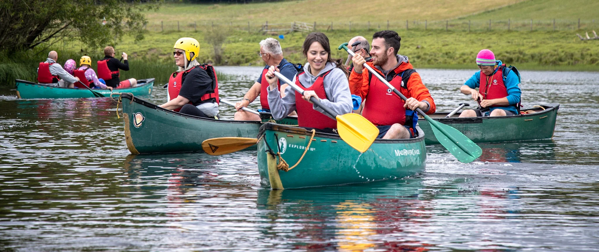 A family enjoying a river canoeing session with Cairngorms Activities