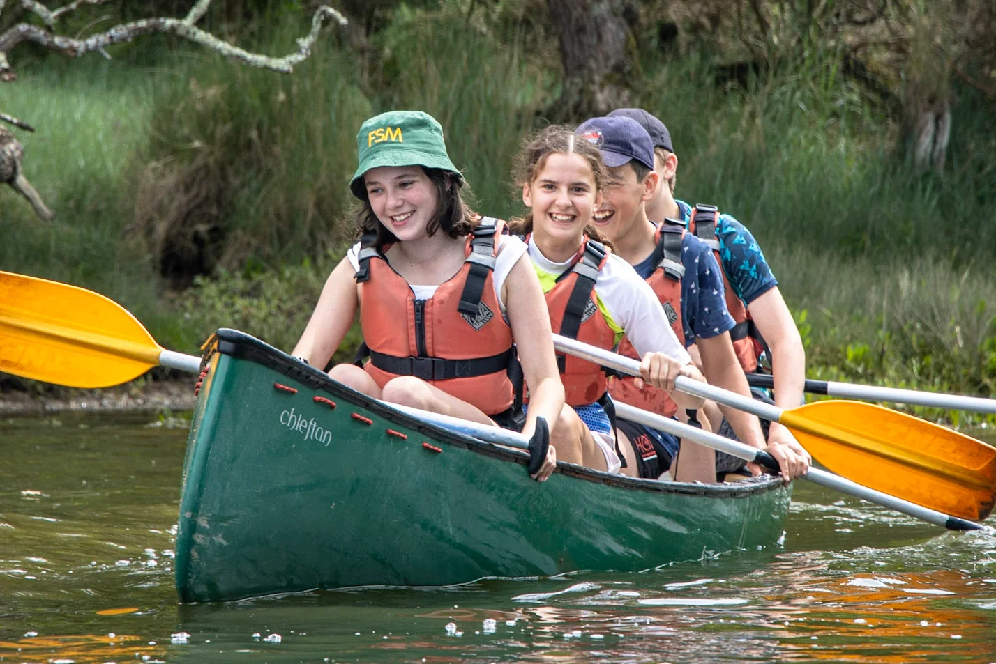 A group of students canoeing on the River Spey