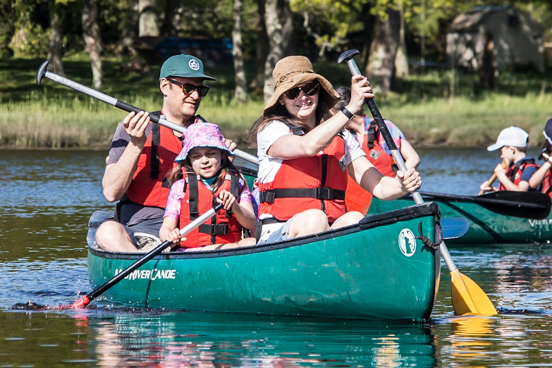 A family enjoying a family canoeing session with New Forest Activities.