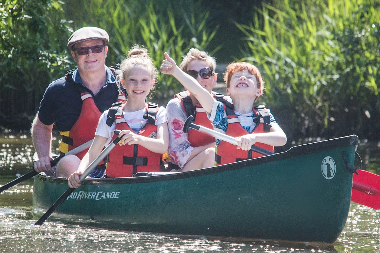 A family canoeing on our purpose built paddling pond