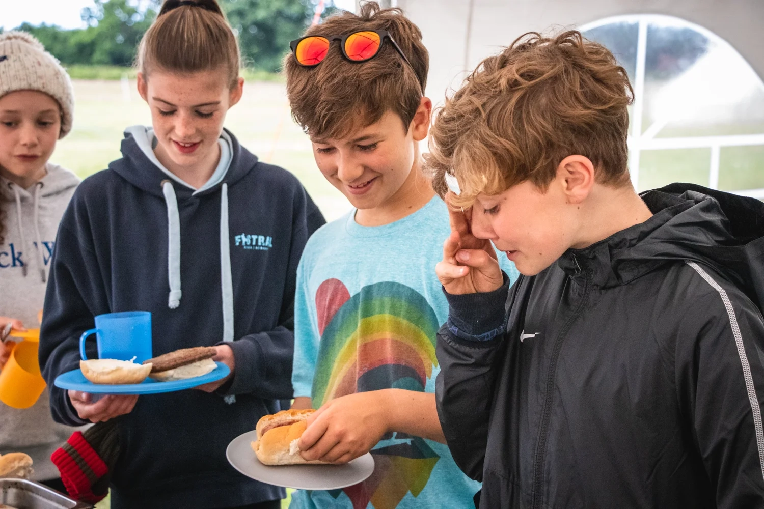 A youth group enjoying hearty food during a residential trip