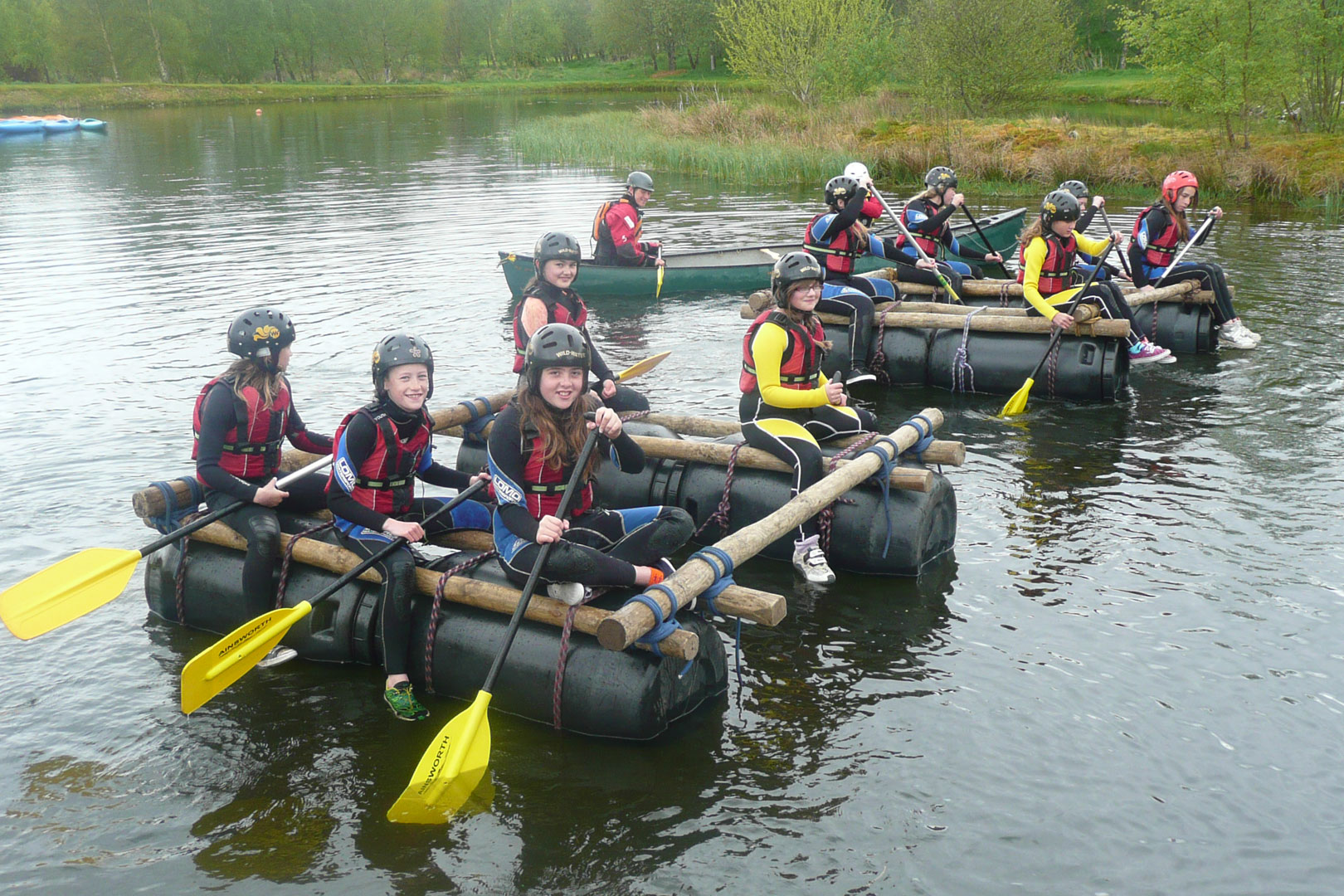 A group of friends building rafts during a raft building party