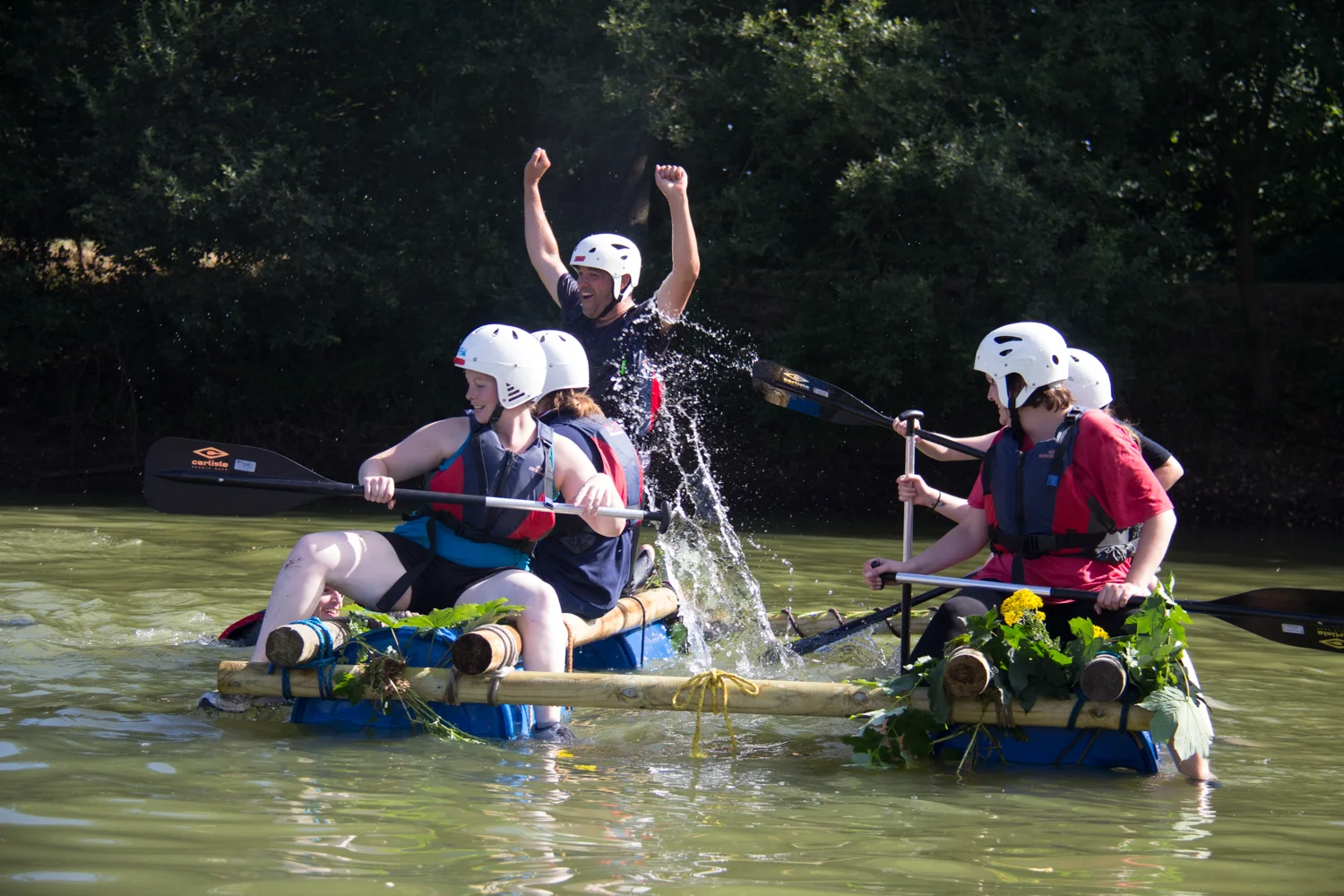 A corporate group working together on raft building at Cairngorms Activities