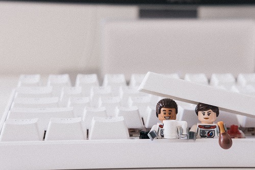 Helpful toy characters taking a break from fixing the computer keyboard.