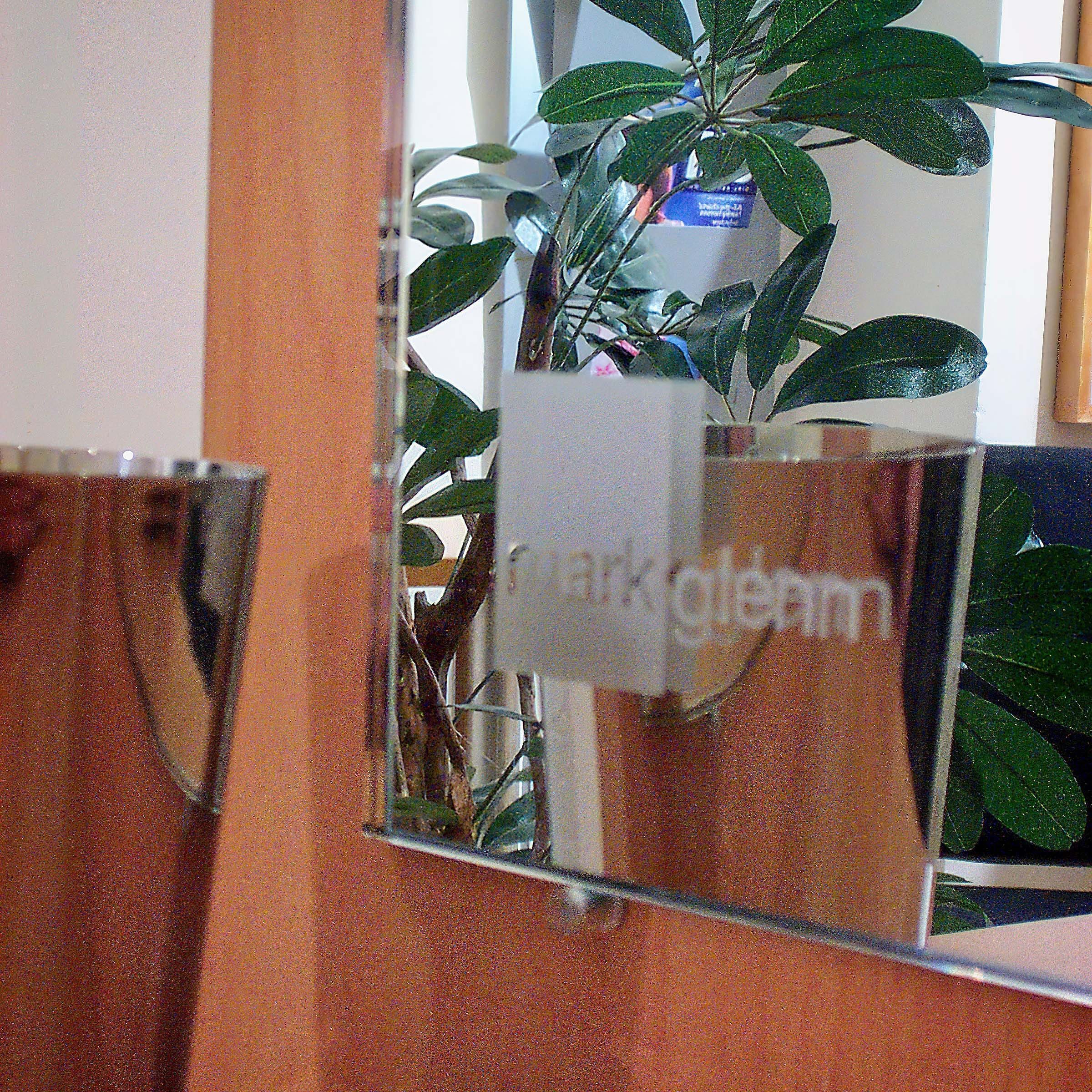 Mark Glenn logo mirror at their first hair extension studio in London's New Bond Street, 2001