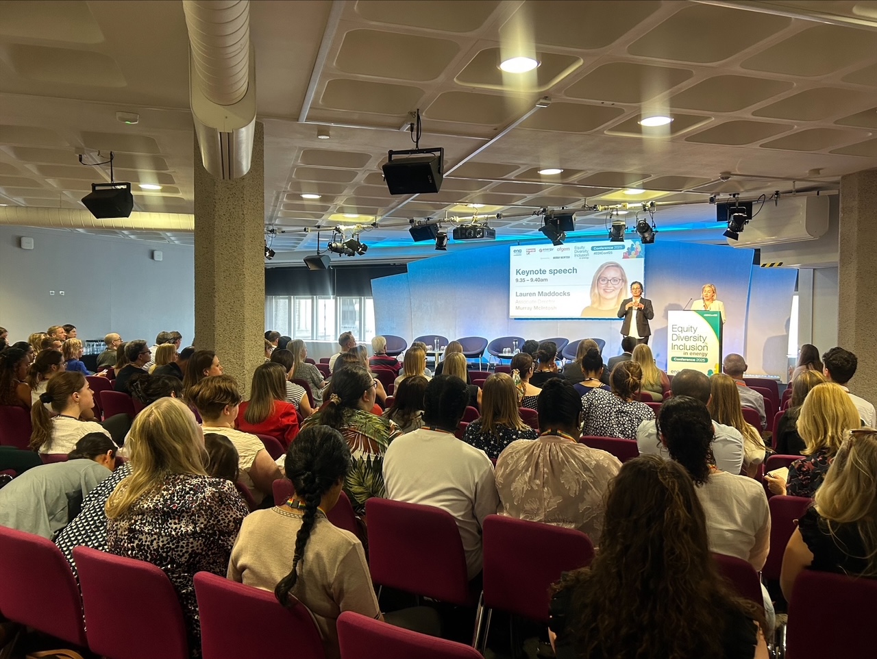 A room full of people listening to Lauren Maddock's speech
