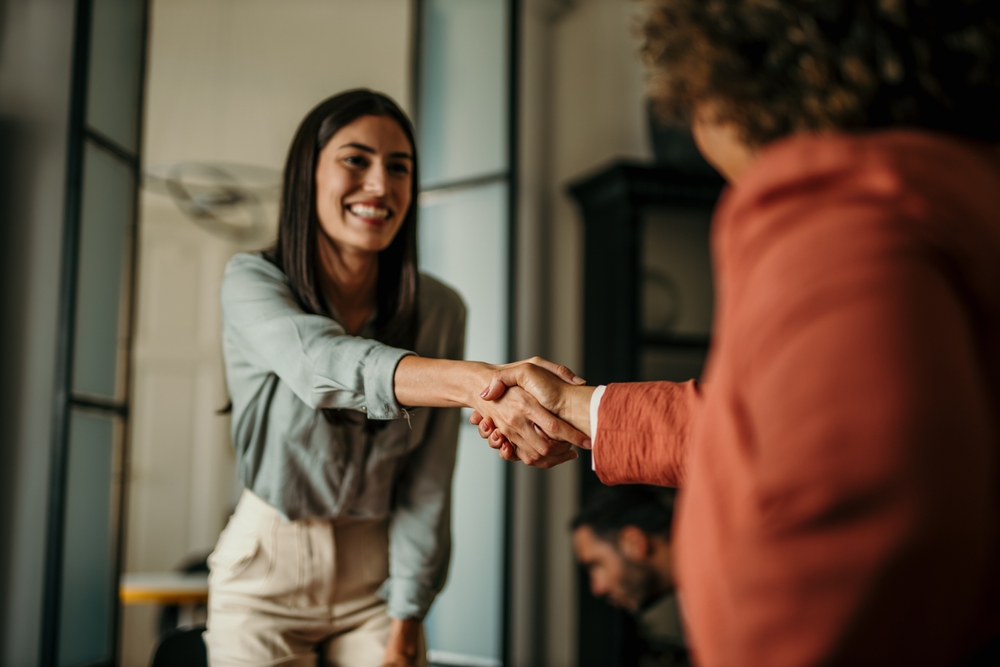 two woman shaking hands
