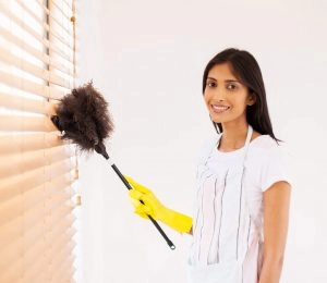 a-lady-is-cleaning-the-wodden-venetial-blinds